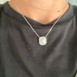 Diamond necklace with emerald center stone
